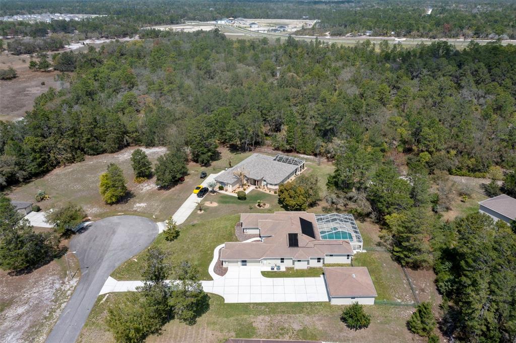 10130 Lazy Days Court Weeki Wachee, FL 34613 - Photo 85 of 85 an aerial view of a house with a yard
