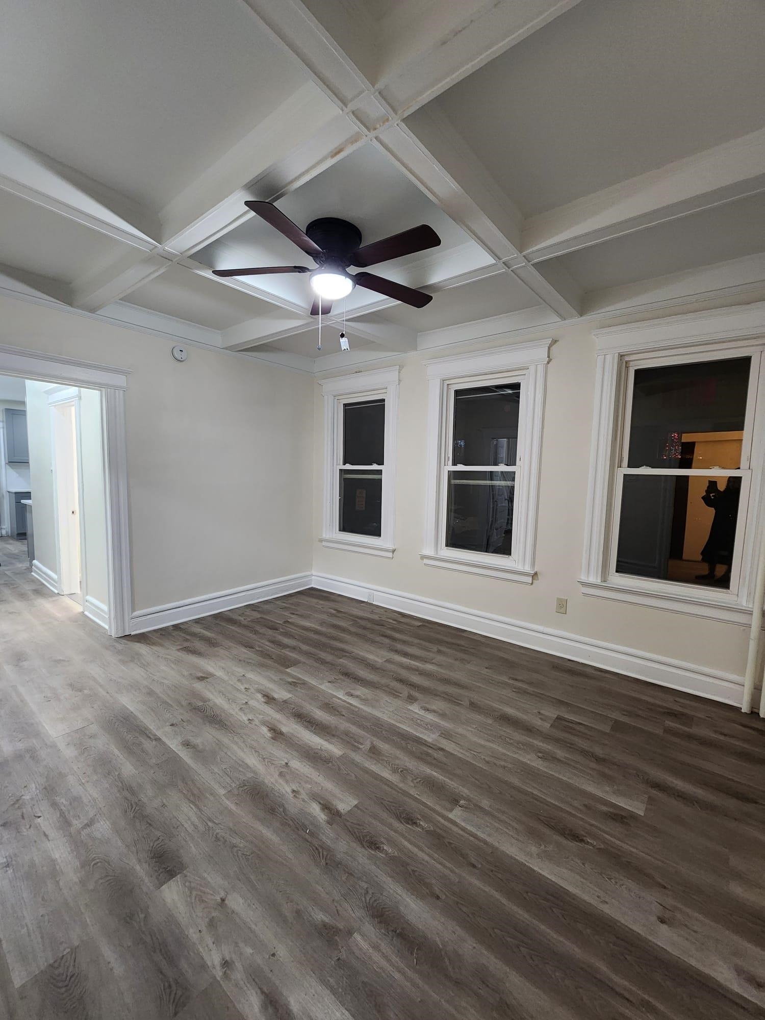 65 Halstead Street, Unit 2 Kearny, NJ 07032 - Photo 9 of 16 a view of an empty room with wooden floor and a window