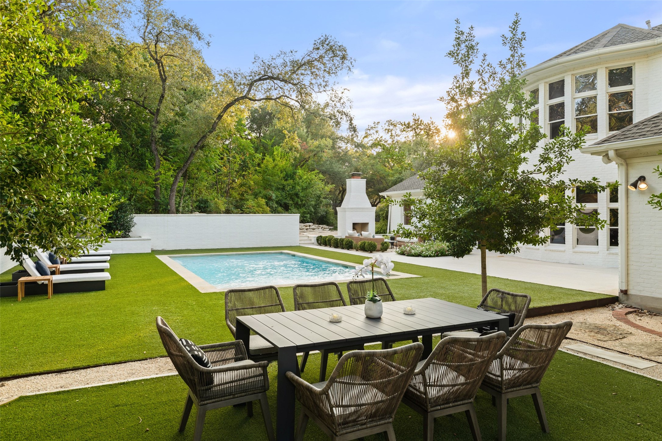 4201 Green Cliffs Road Austin, TX 78746 - Photo 30 of 40 A dedicated outdoor dining area set against artificial turf and native landscaping provides the backdrop for weekend barbecues with family and neighbors
