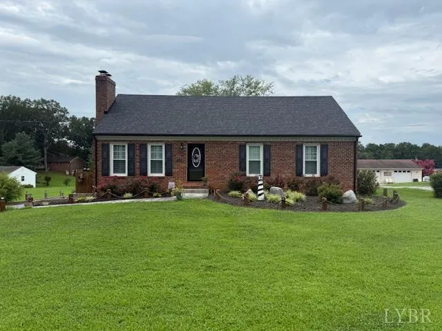 a front view of a house with yard patio and green space