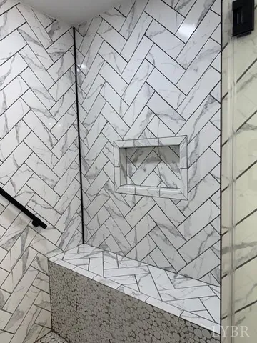 a living room with a bed furniture and a flat screen tv