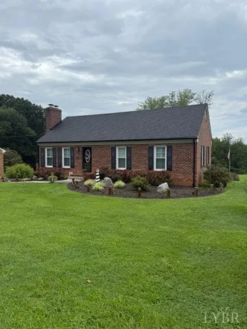 a front view of a house with yard and green space