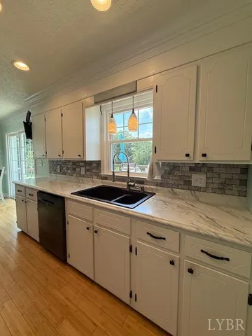 a bathroom with a granite countertop sink a toilet and a shower