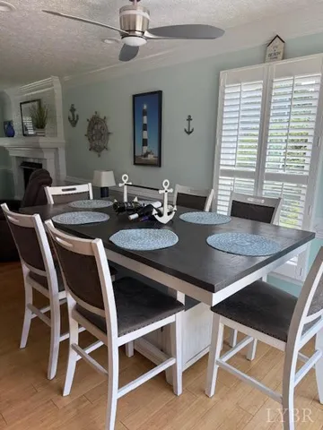 a living room with furniture a flat screen tv and kitchen view