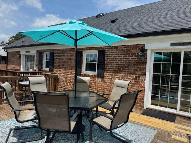 a view of a hallway with wooden floor and paintings on the wall