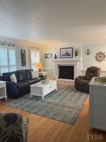 a living room with furniture and a fireplace