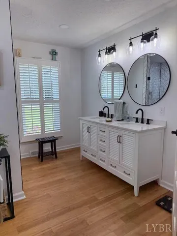 a view of a room with wooden floor potted plant and a window