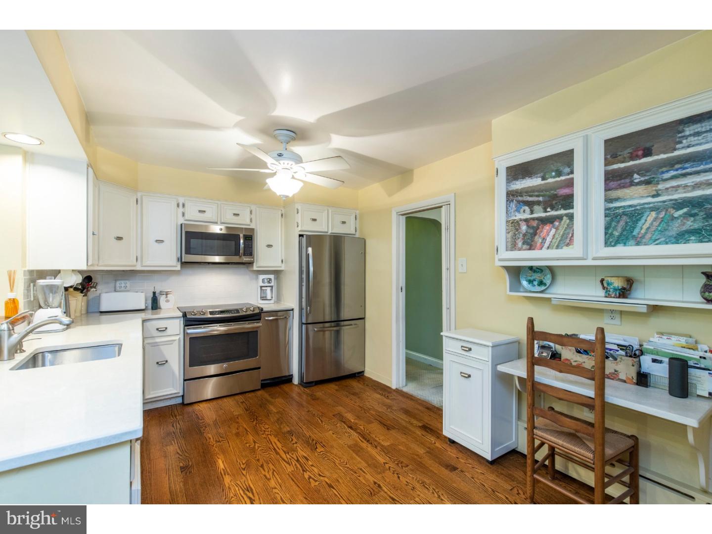 67 North Hillcrest Road Springfield, PA 19064 - Photo 11 of 23 a kitchen with stainless steel appliances granite countertop a refrigerator a stove a sink dishwasher and white cabinets with wooden floor