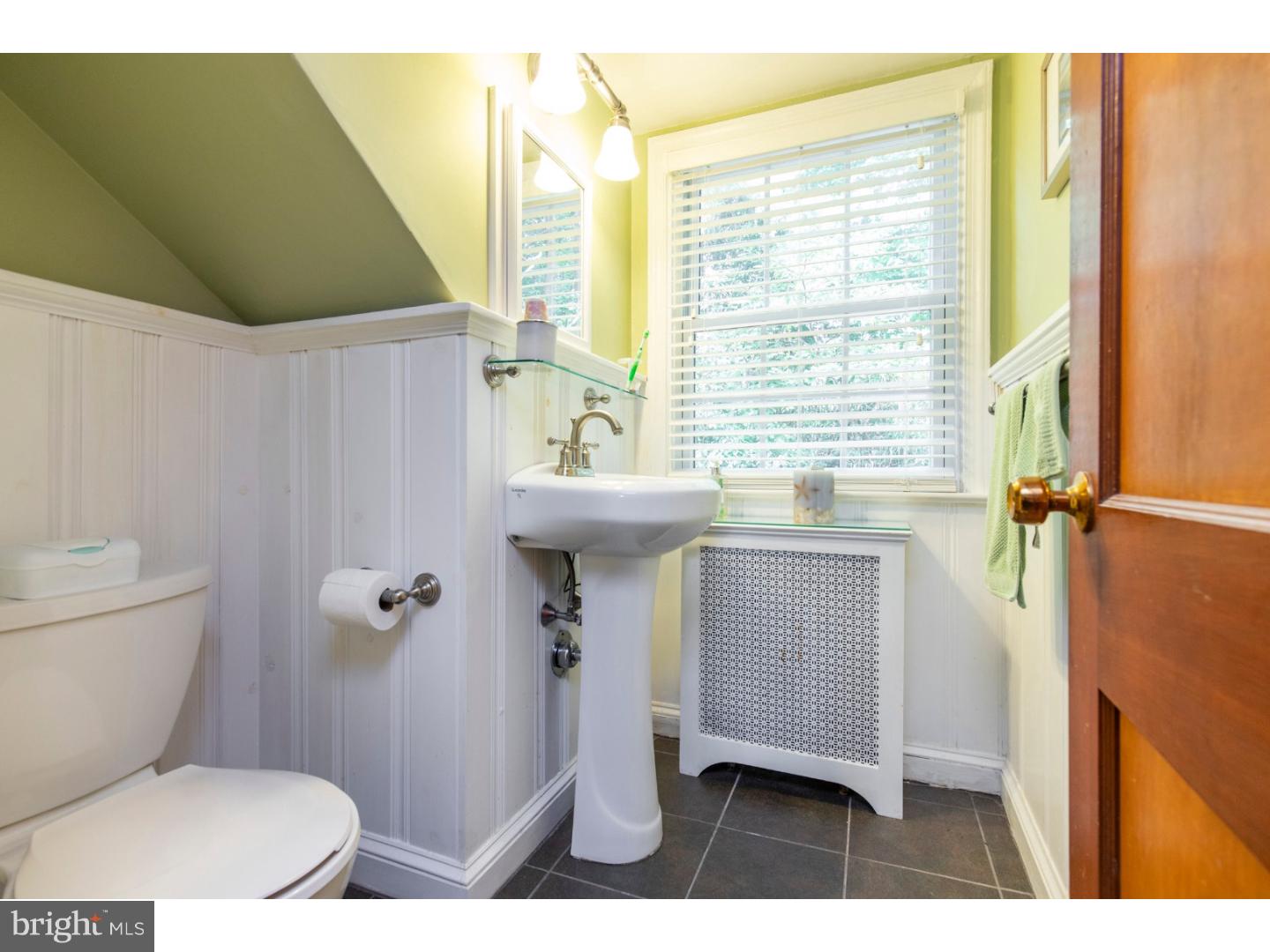 67 North Hillcrest Road Springfield, PA 19064 - Photo 19 of 23 a bathroom with a toilet a sink and a window