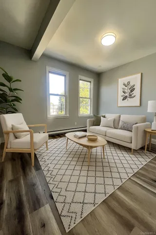 a living room with furniture rug and window