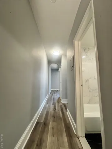 a view of hallway with wooden floor