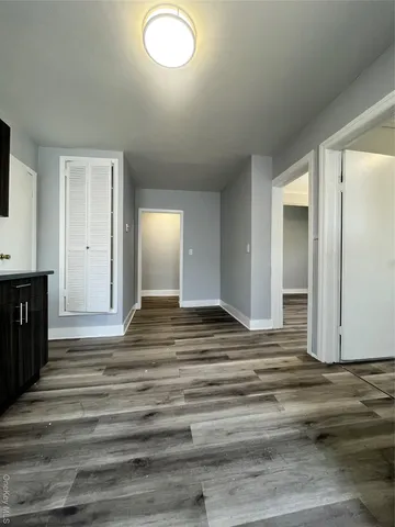 a view of a livingroom with wooden floor and cabinet