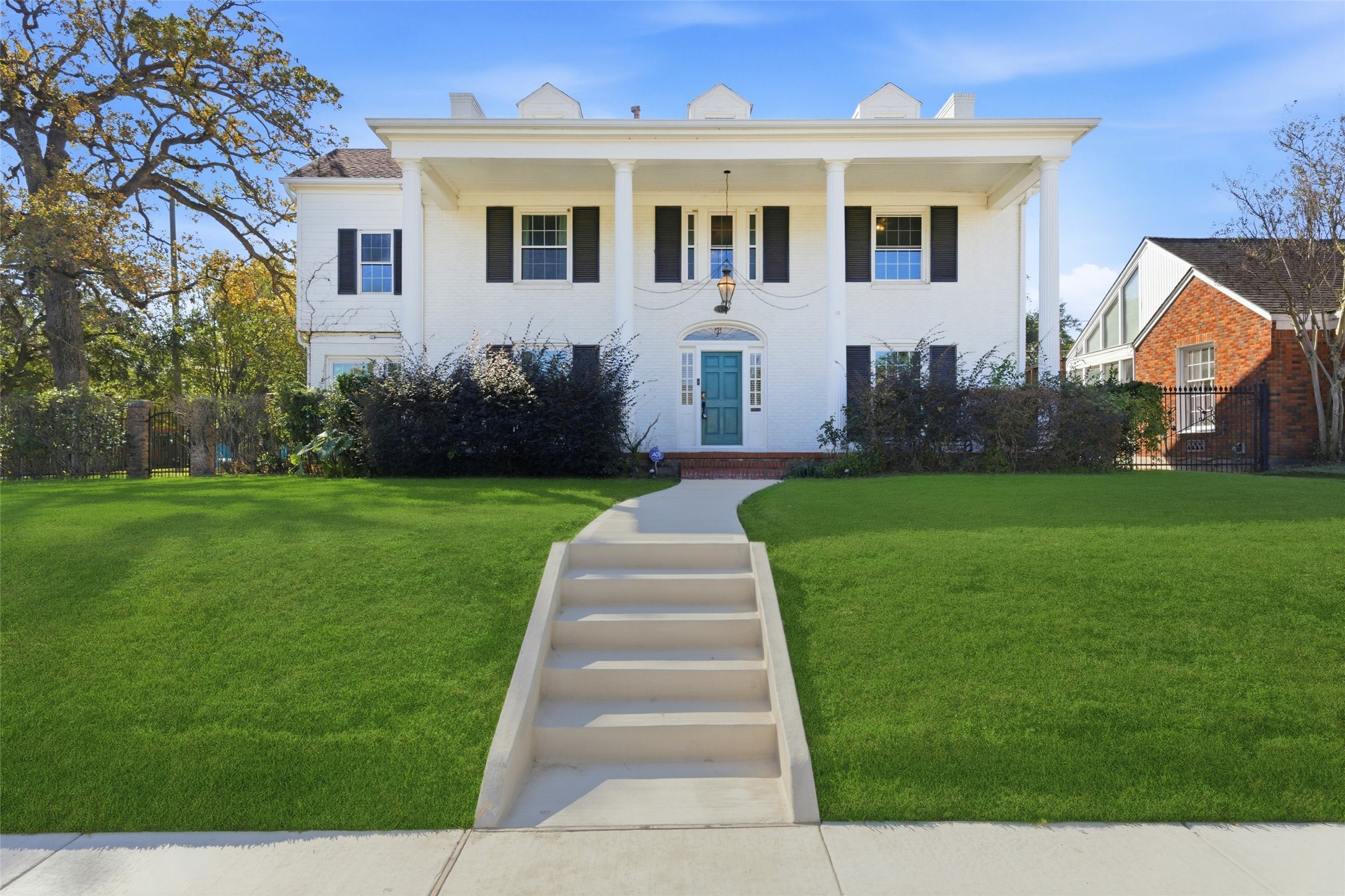 a front view of house with yard and green space