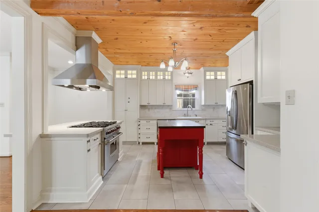 a kitchen with stainless steel appliances granite countertop a refrigerator and a stove