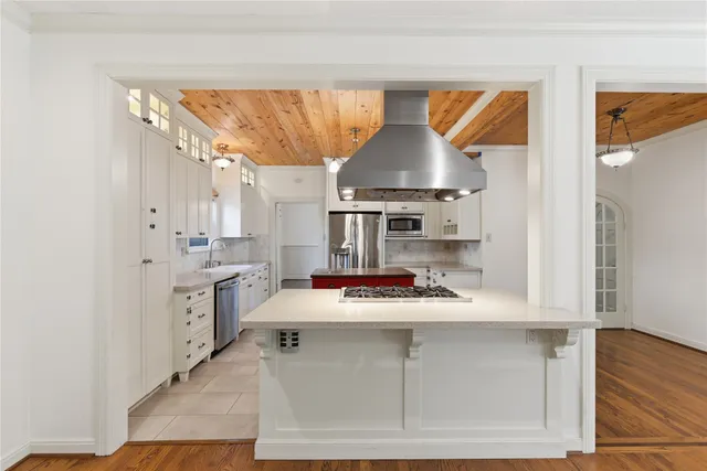 a kitchen with a stove a sink and a refrigerator