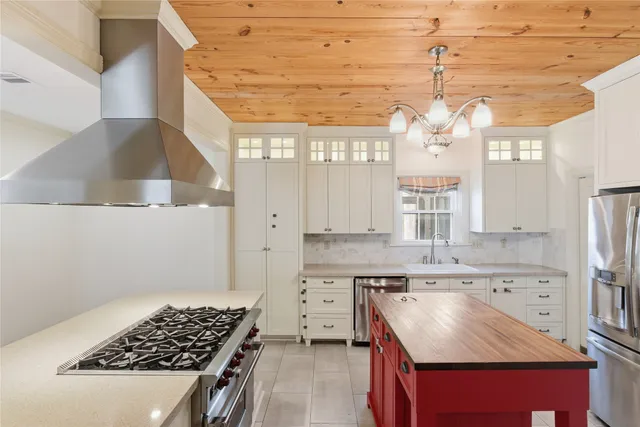 a kitchen with a stove a sink and a refrigerator