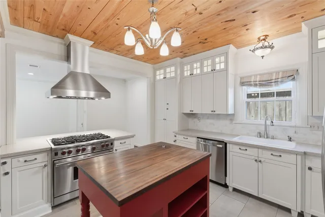 a kitchen with a stove a sink and a refrigerator