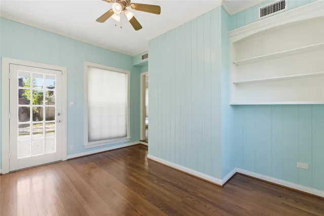 wooden floor in an empty room with a window