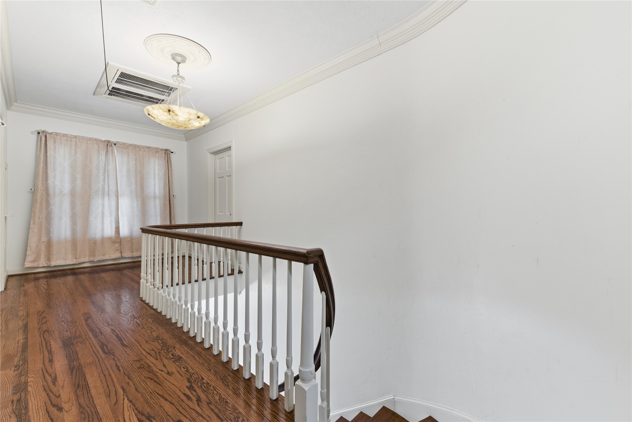6666 Fairfield Street Houston, TX 77023 - Photo 24 of 48 a view of a hallway with wooden floor and staircase