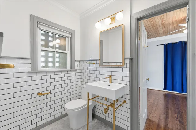 a bathroom with a sink a toilet and mirror