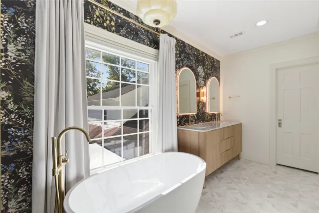 a bathroom with a tub sink and mirror