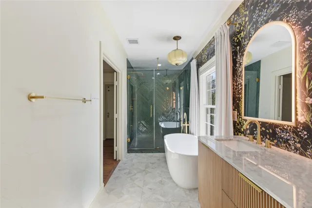 a spacious bathroom with a granite countertop sink and a mirror