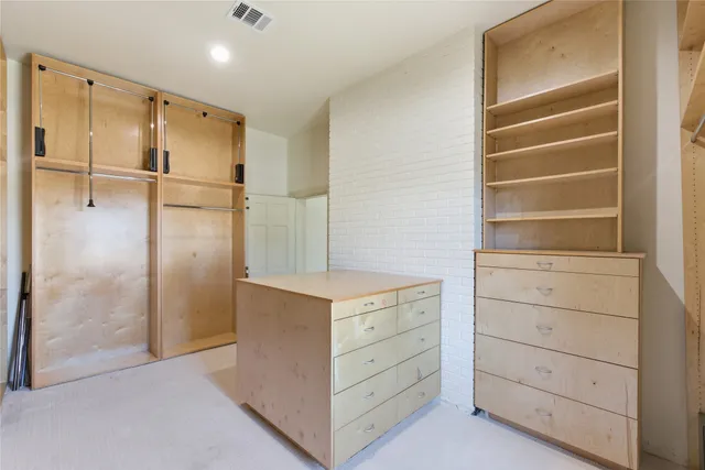 a hallway with cabinets and wooden closet