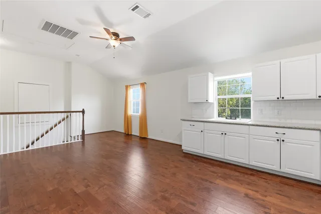 a view of a kitchen with sink cabinets and wooden floor