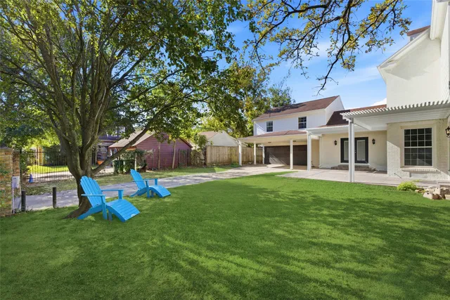 a front view of a house with a yard table and chairs
