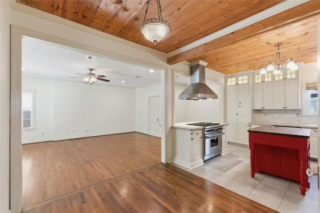 a kitchen with granite countertop stainless steel appliances a stove top oven a sink and cabinets