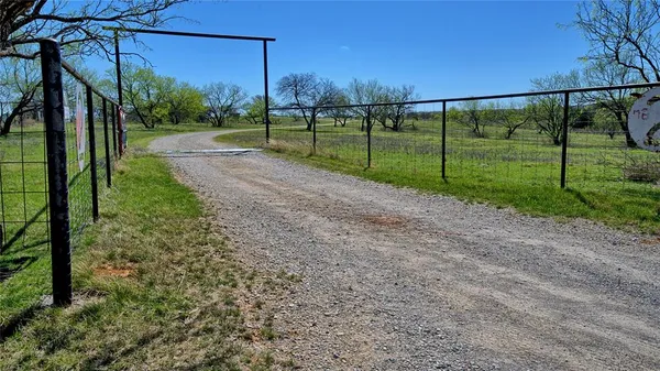 a view of a backyard with wooden fence