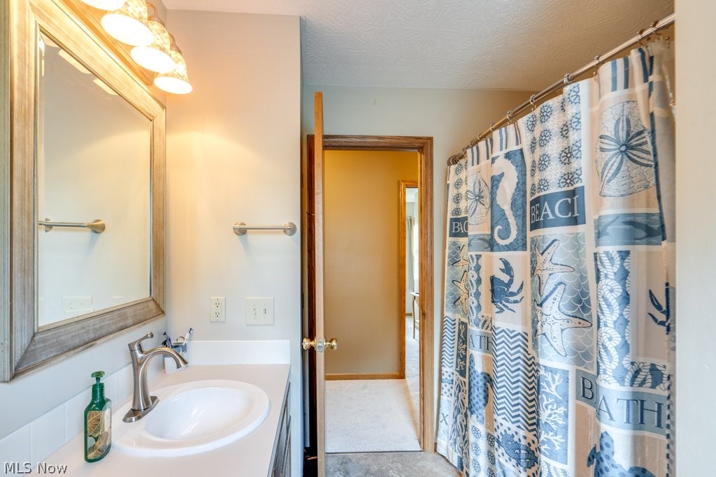 826 Stewart Road Kent, OH 44240 - Photo 39 of 43 Bathroom featuring vanity, a textured ceiling, and tile patterned flooring