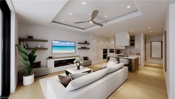 a living room with fireplace furniture and a kitchen view