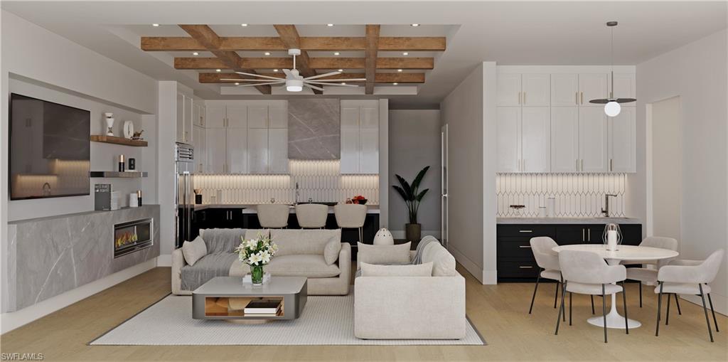 180 9th Street South, Unit 301 Naples, FL 34102 - Photo 2 of 8 a living room with furniture and a chandelier