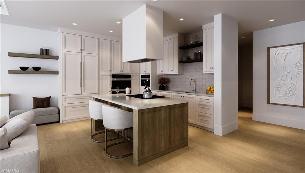 180 9th Street South, Unit 301 Naples, FL 34102 - Photo 2 of 5 a kitchen with a sink a counter top space stainless steel appliances and cabinets