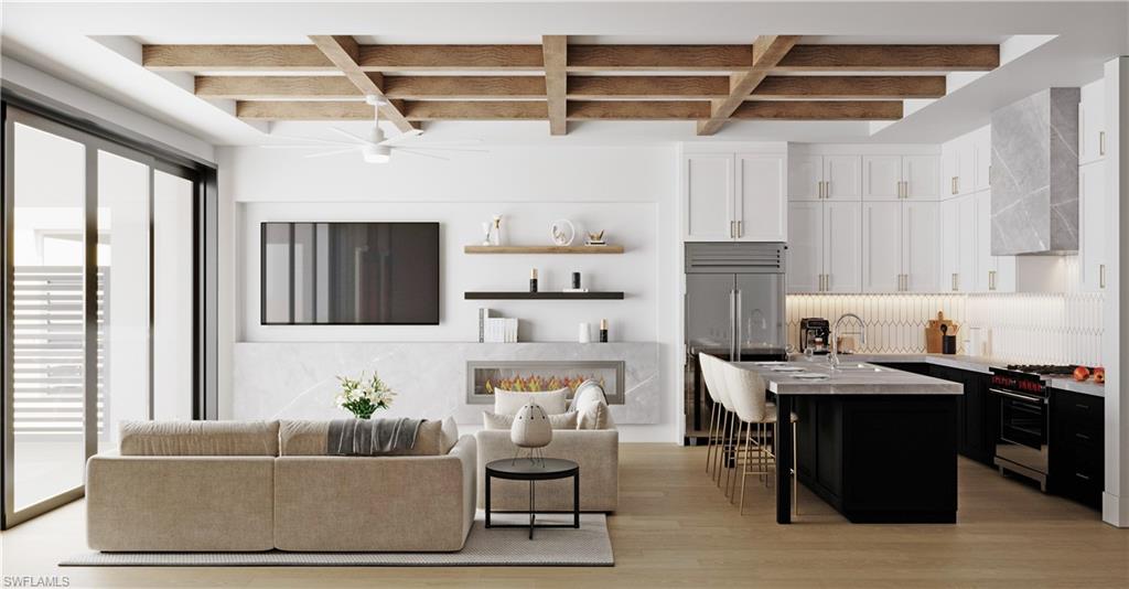 180 9th Street South, Unit 301 Naples, FL 34102 - Photo 3 of 8 a living room with furniture and a window