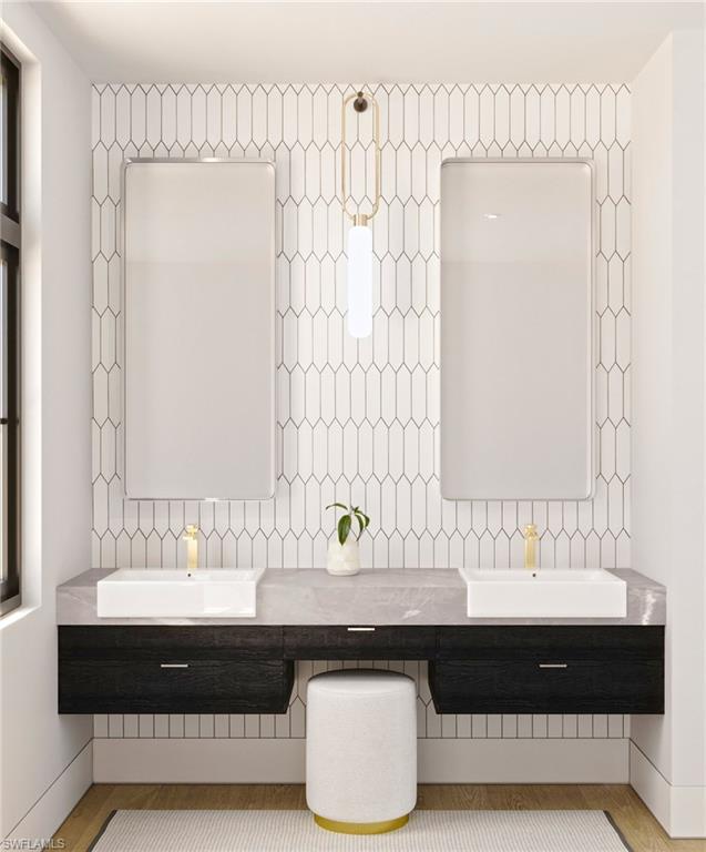 180 9th Street South, Unit 301 Naples, FL 34102 - Photo 5 of 8 a bathroom with a bathtub and a sink