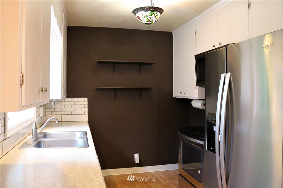 8325 Custer Road Southwest Lakewood, WA 98499 - Photo 13 of 20 a kitchen with a refrigerator and a sink