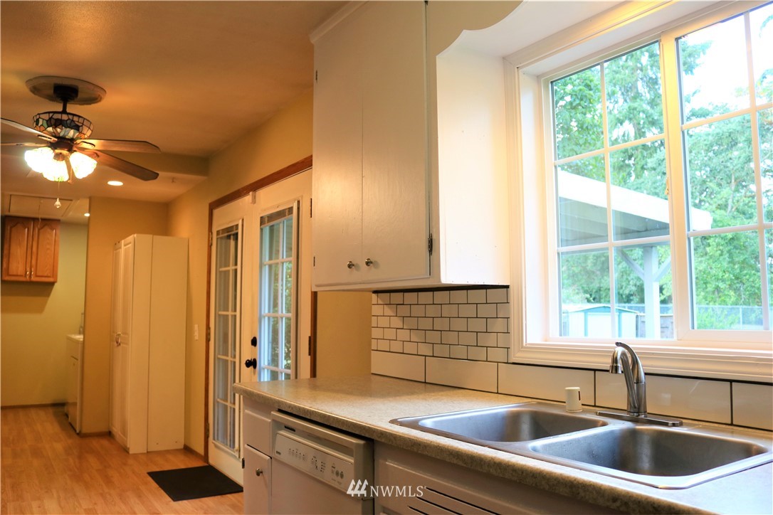 8325 Custer Road Southwest Lakewood, WA 98499 - Photo 14 of 20 a kitchen with a sink and a window