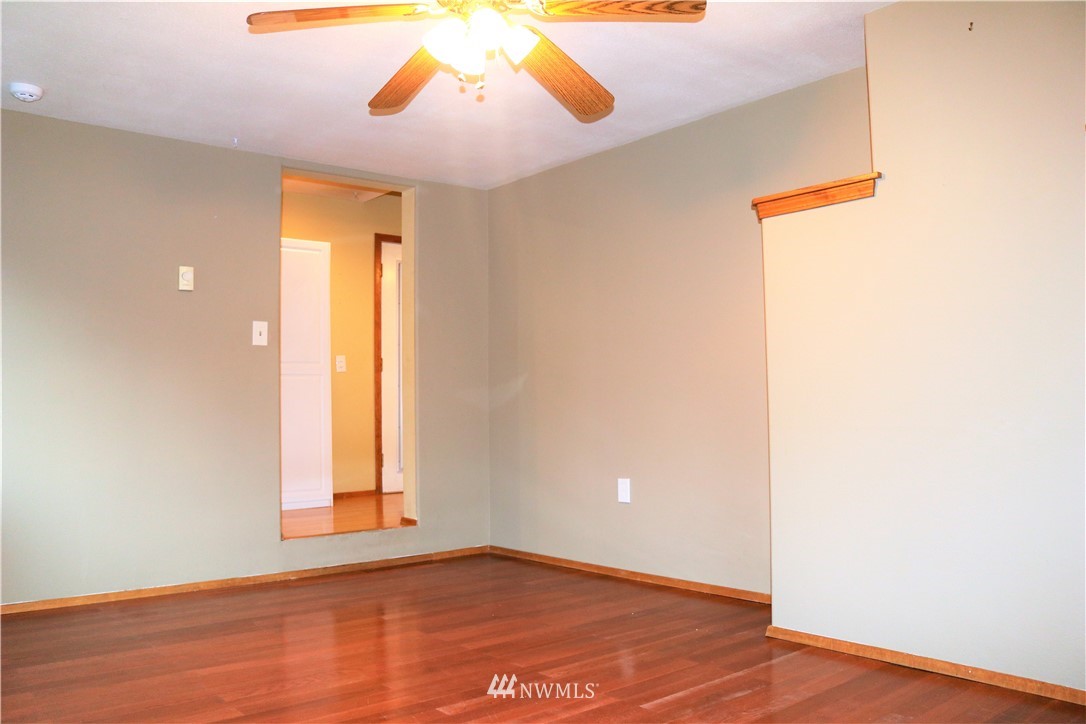 8325 Custer Road Southwest Lakewood, WA 98499 - Photo 17 of 20 an empty room with wooden floor and windows