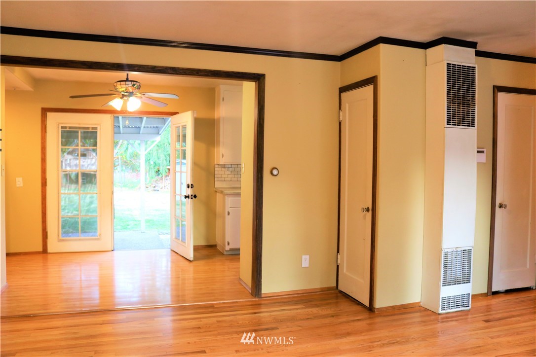 8325 Custer Road Southwest Lakewood, WA 98499 - Photo 7 of 20 a view of empty room with wooden floor and windows