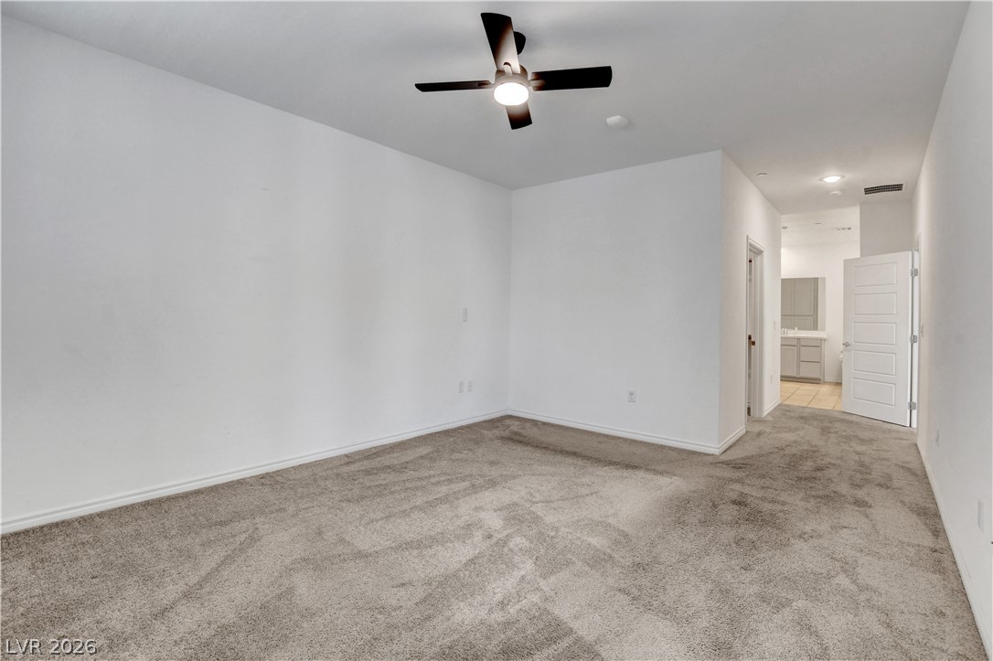 2555 Hampton Road, Unit 2207 Henderson, NV 89052 - Photo 26 of 74 A well-proportioned bedroom with soft carpeting and an overhead ceiling fan offers a peaceful retreat.
