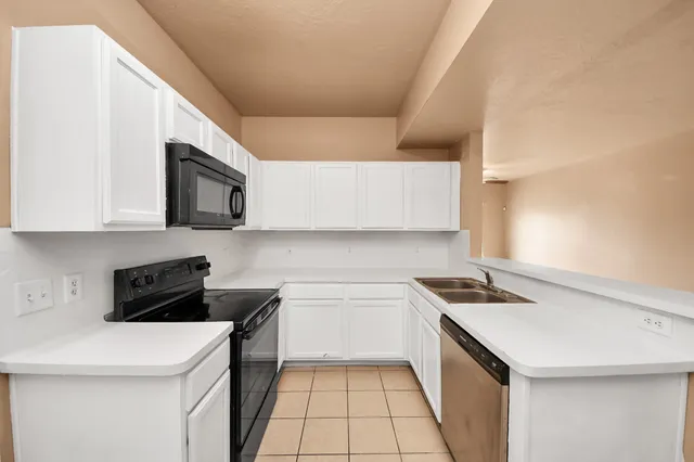 a utility room with cabinets washer and dryer
