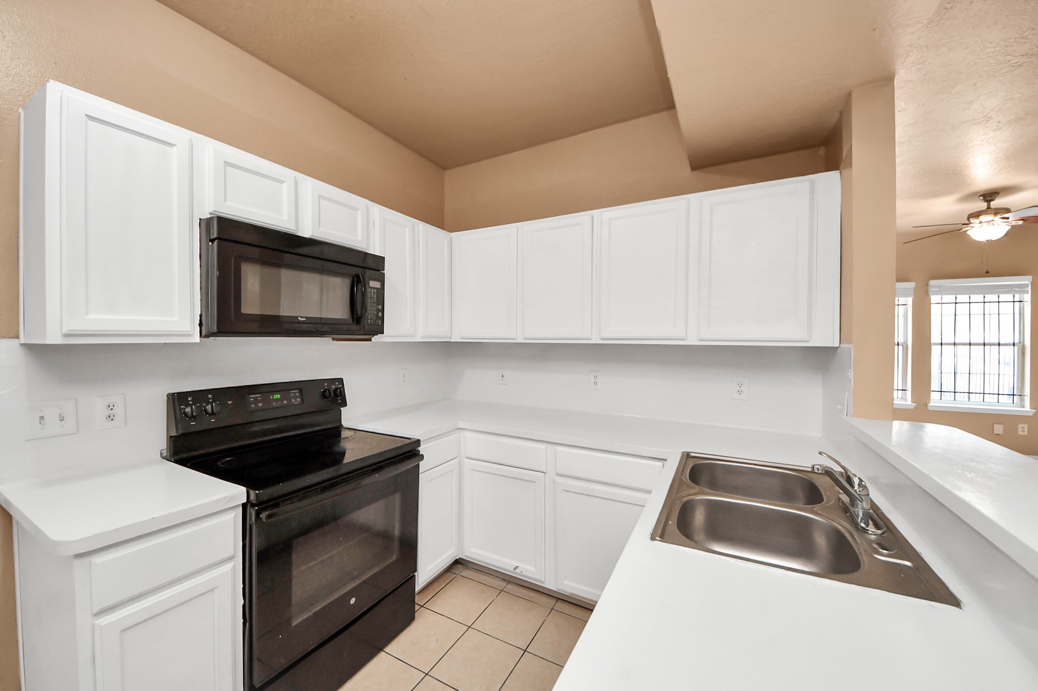8130 Jutland Road Houston, TX 77033 - Photo 23 of 47 a kitchen with a sink stove and microwave