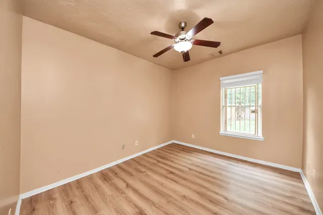 a view of a room with wooden floor and bathroom