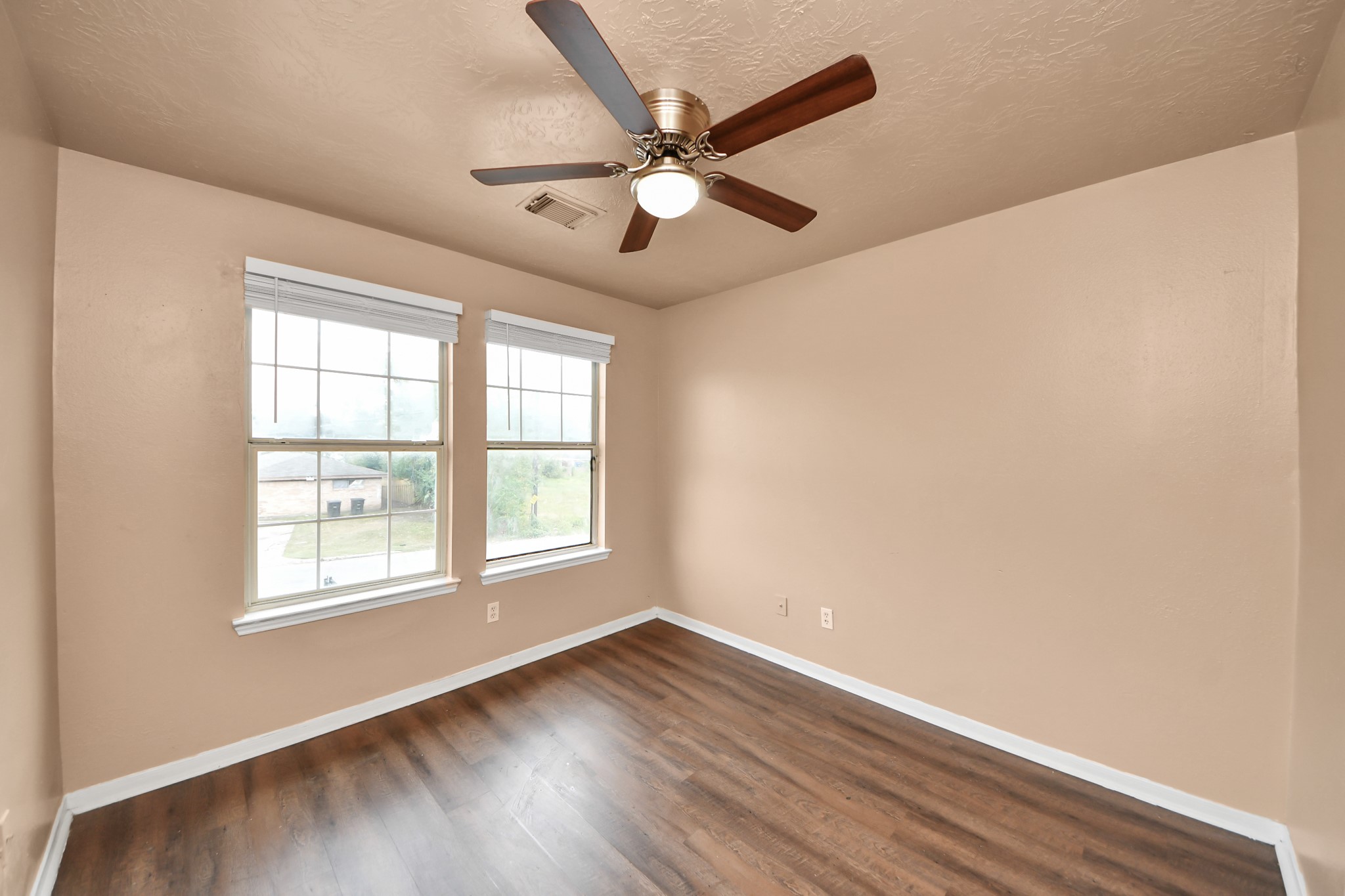 8130 Jutland Road Houston, TX 77033 - Photo 30 of 47 a view of an empty room with wooden floor and a window