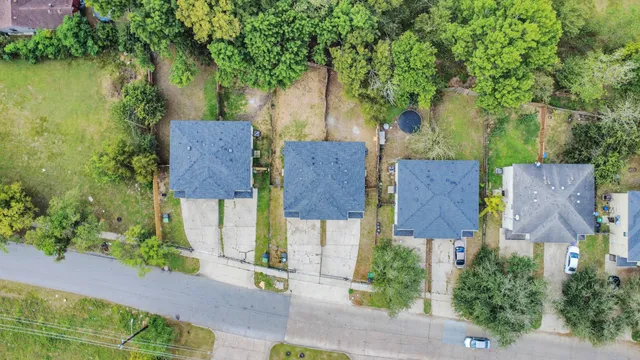 an aerial view of a house with garden space and street view