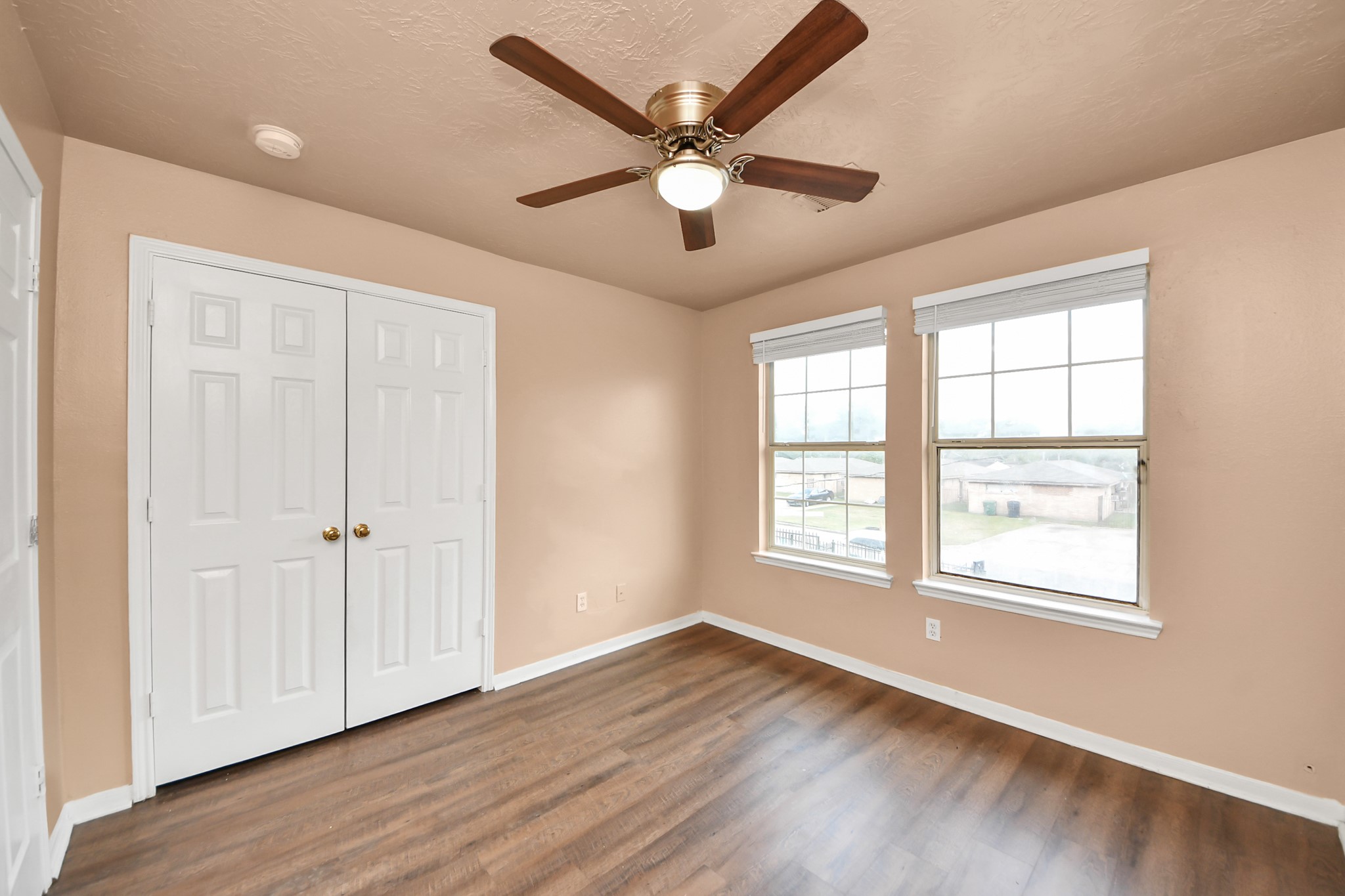 8130 Jutland Road Houston, TX 77033 - Photo 32 of 47 a view of an empty room with wooden floor and a window