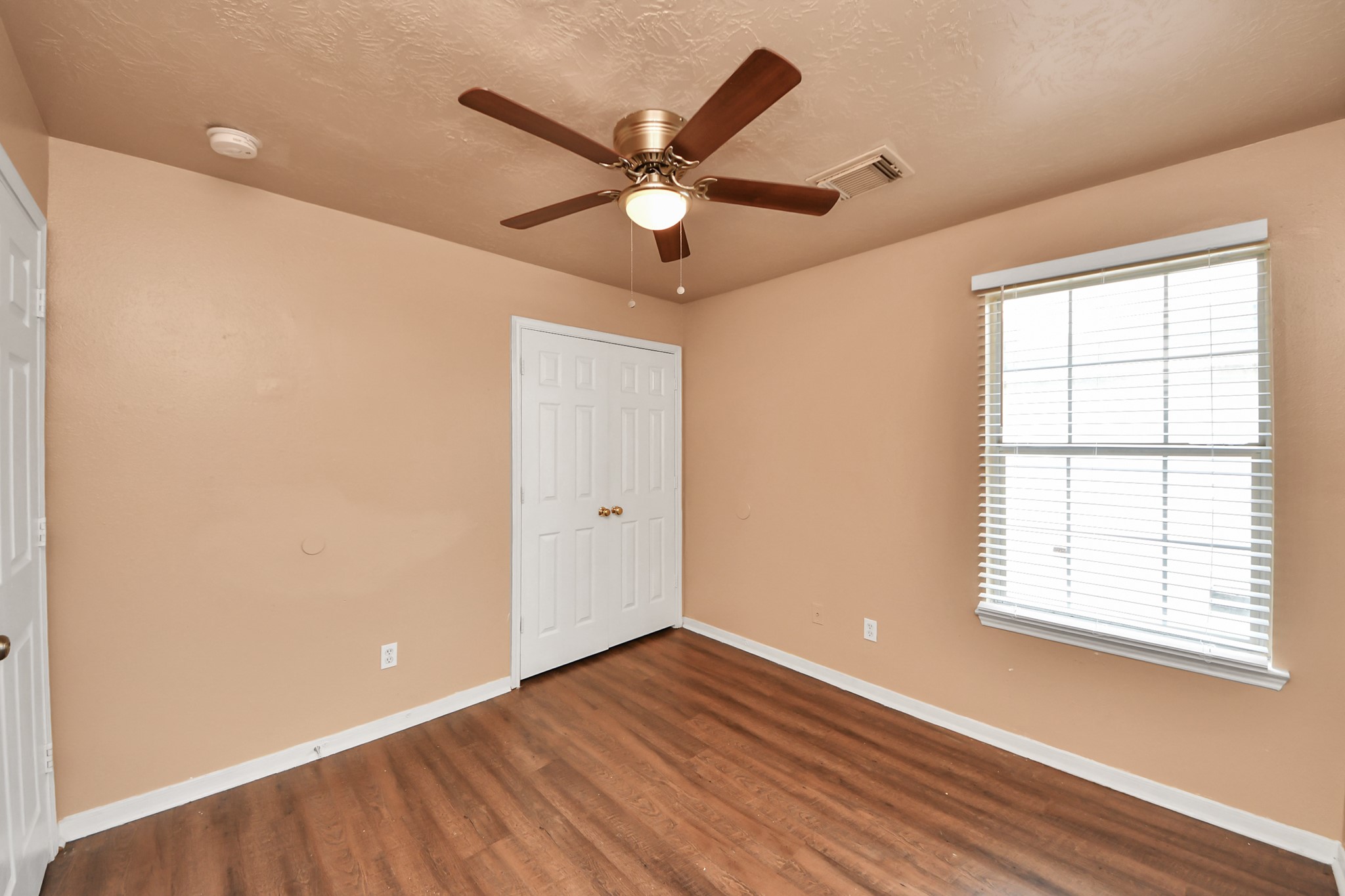 8130 Jutland Road Houston, TX 77033 - Photo 36 of 47 a view of an empty room with wooden floor and a window
