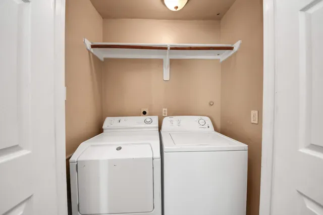 a view of a room with wooden floor and a ceiling fan